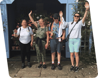 Four Members Of Wiggly Willow Team With Hands In The Air