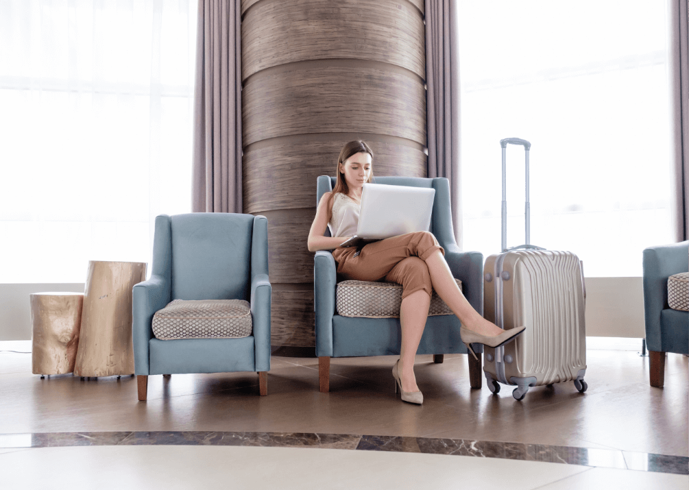 A Lady Working From Her Laptop In Hotel Foyer