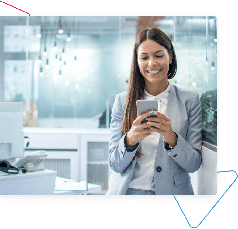 A woman smiling at her smartphone.