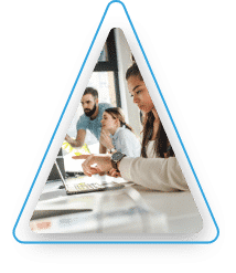 People in an office looking at computer screens.