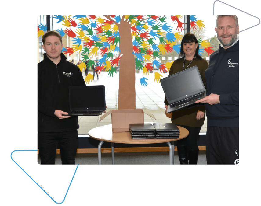 ITVET Team Member and Birchwood Sraff Hold Newly Refurbished Laptops