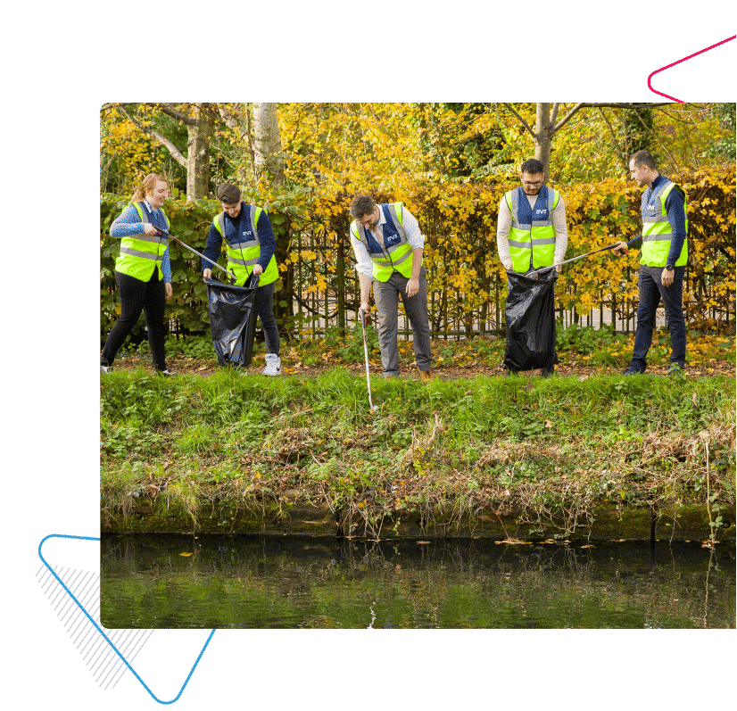 ITVET's team out litter picking next to a river.