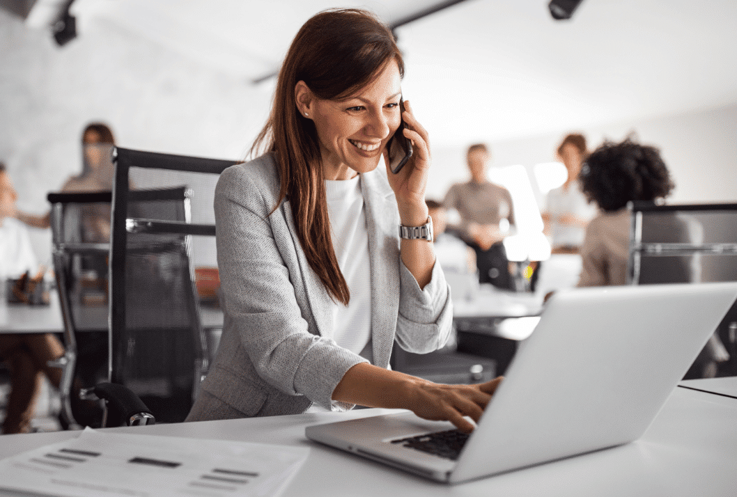 woman on phone and laptop