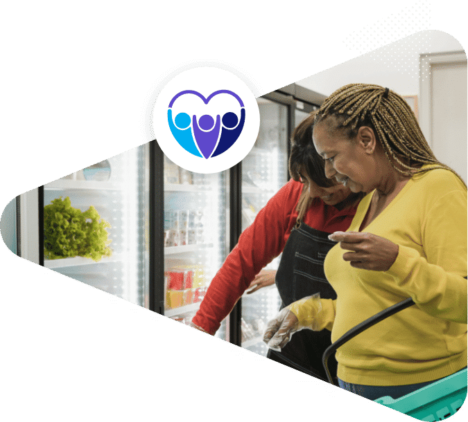 Two ladies getting groceries from a community fridge