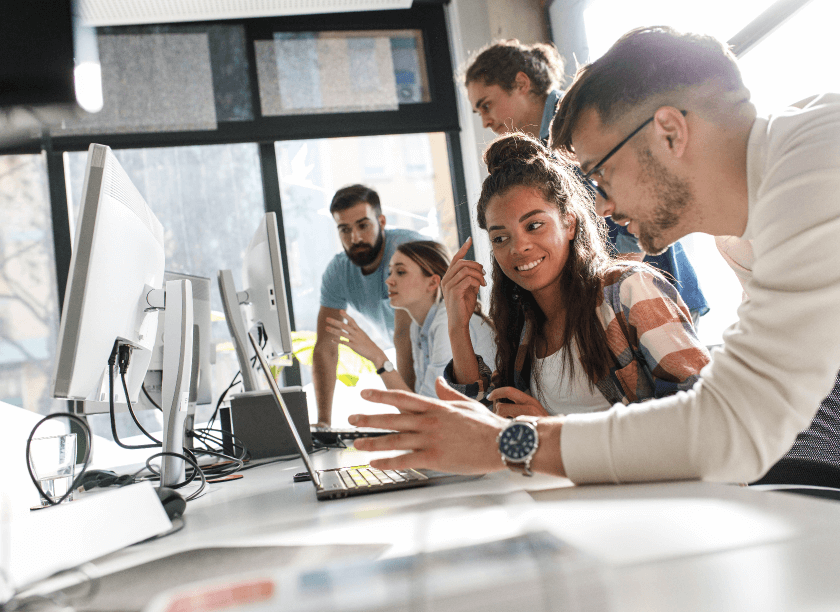 People in an office looking at computer screens.