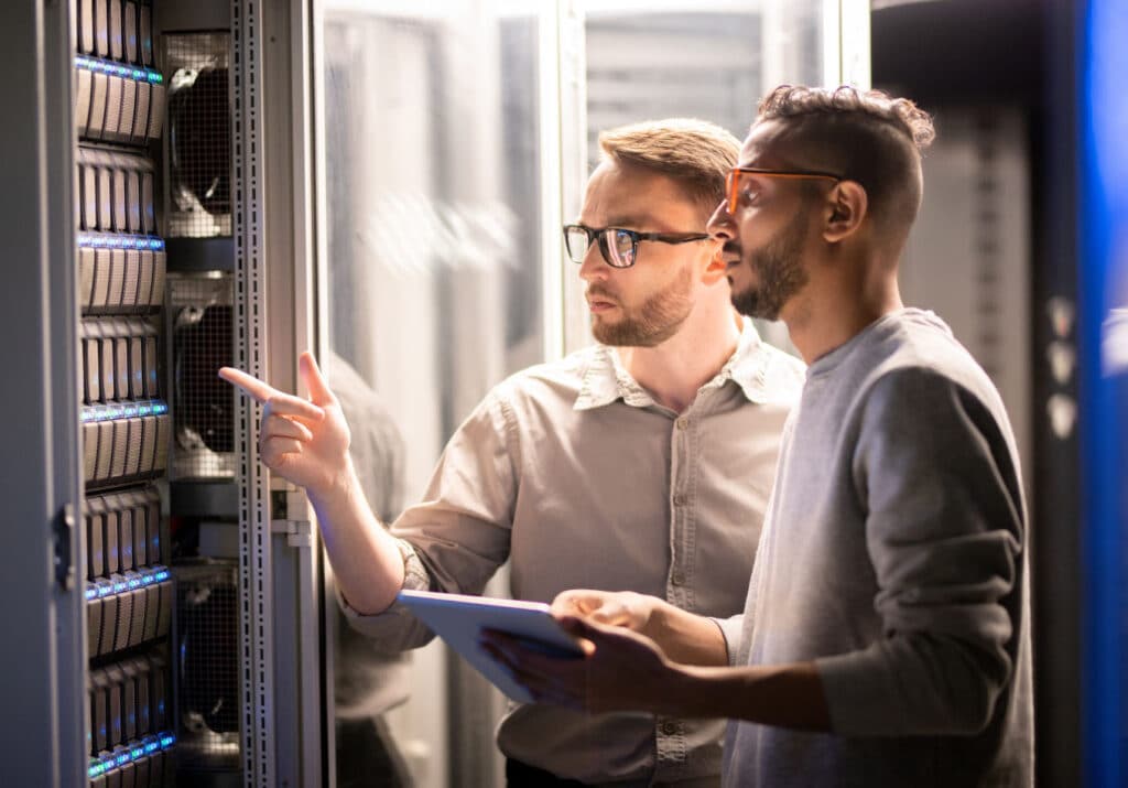 two men looking at a server