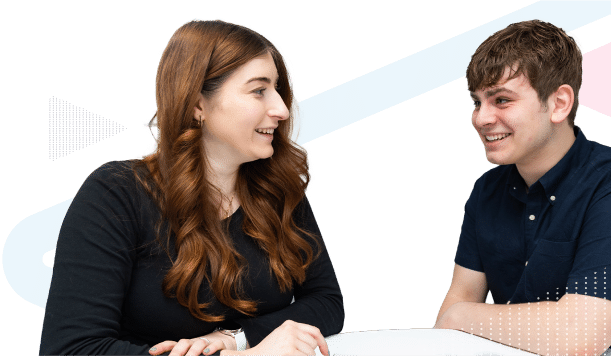 Two work colleagues smiling at each other.