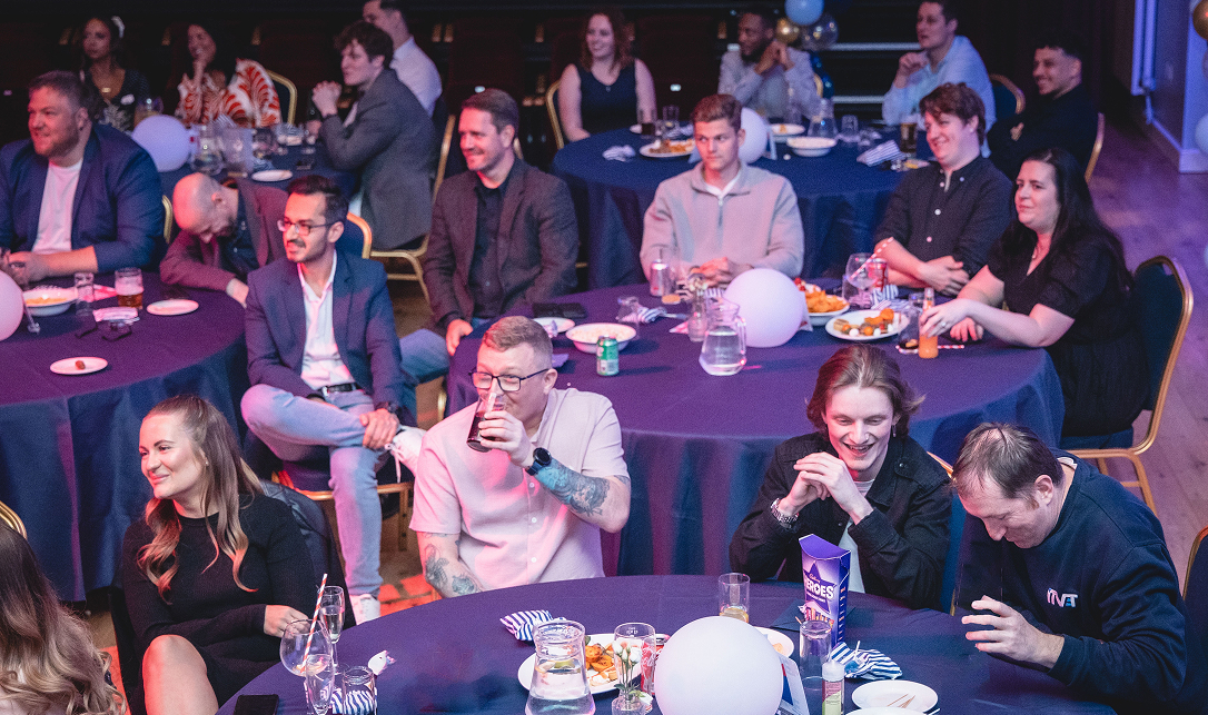 ITVET employees at the internal Teammate Awards sitting and laughing at tables